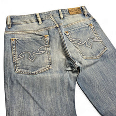 TWC Vintage Diesel Zaghor Bootcut Jeans in verwaschenem Blau mit markanter weißer Stickerei auf den Gesäßtaschen
