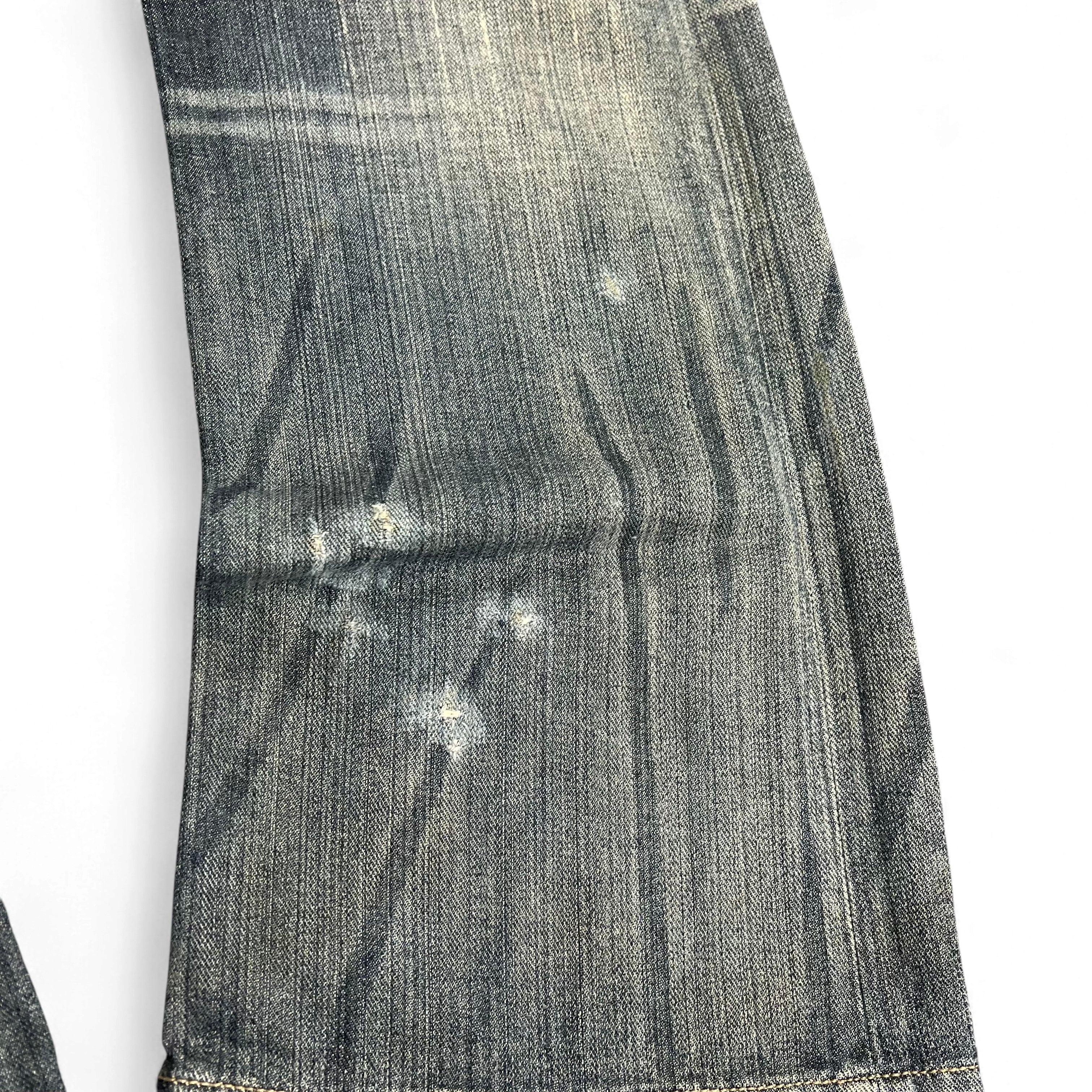 TWC Vintage Armani Jeans mit verwaschener blauer Optik und dezenten Abnutzungsspuren am Hosenbein