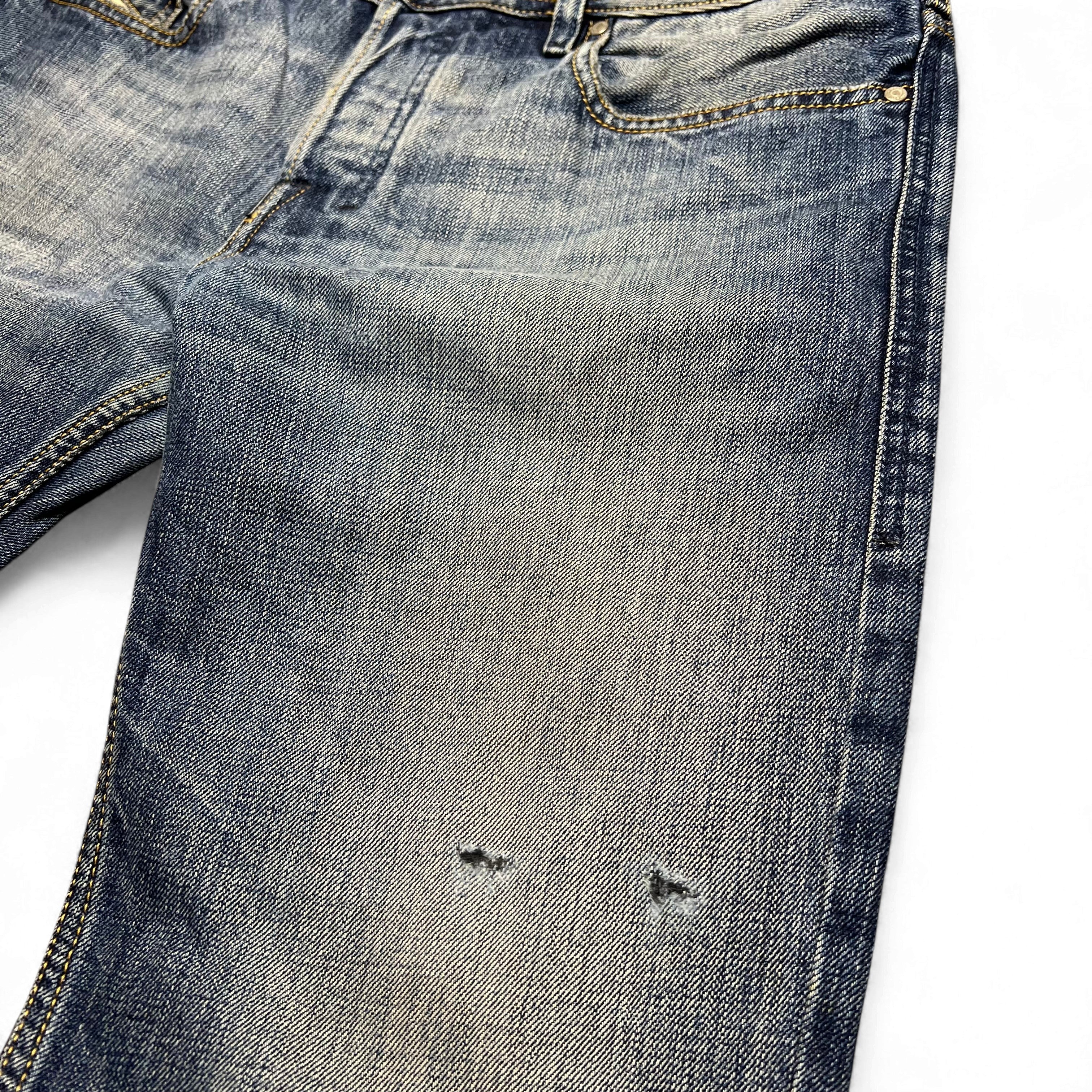 TWC Vintage Diesel Zatiny Bootcut Jeans in verwaschenem Blau mit Distressed-Details und kleinen Löchern