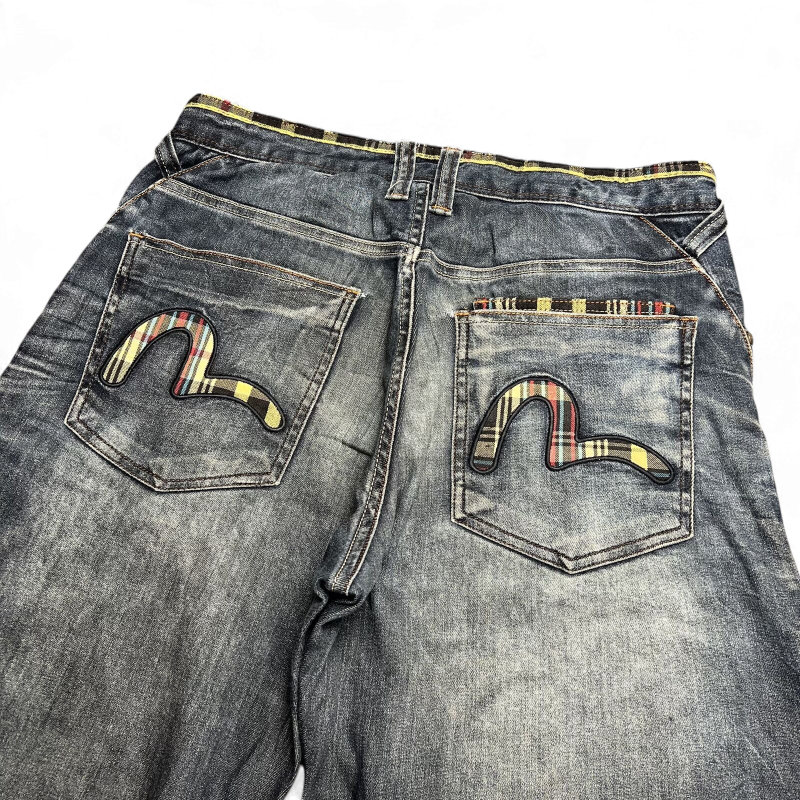 TWC Vintage Evisu Jeans mit geradem Schnitt, verwaschenem Denim und karierten Seagull-Logos auf den Gesäßtaschen.