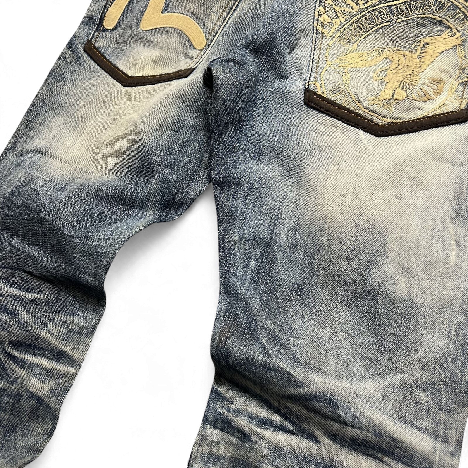 TWC Vintage Evisu Jeans mit verwaschener blauer Waschung, bestickten Gesäßtaschen und Lederdetails
