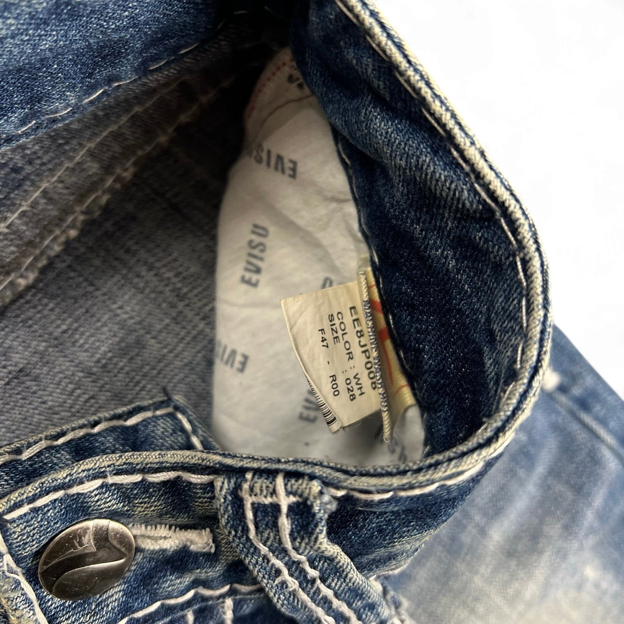 TWC Vintage Evisu straight leg blue denim jeans with white interior branding and size tag detail