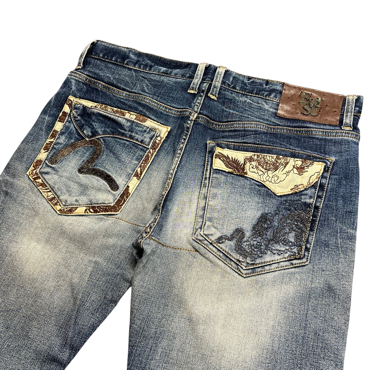 TWC Vintage Evisu straight leg jeans in blue denim with decorative embroidered back pockets and leather brand patch.