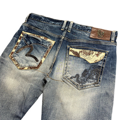TWC Vintage Evisu straight leg jeans in blue denim with decorative embroidered back pockets and leather brand patch.