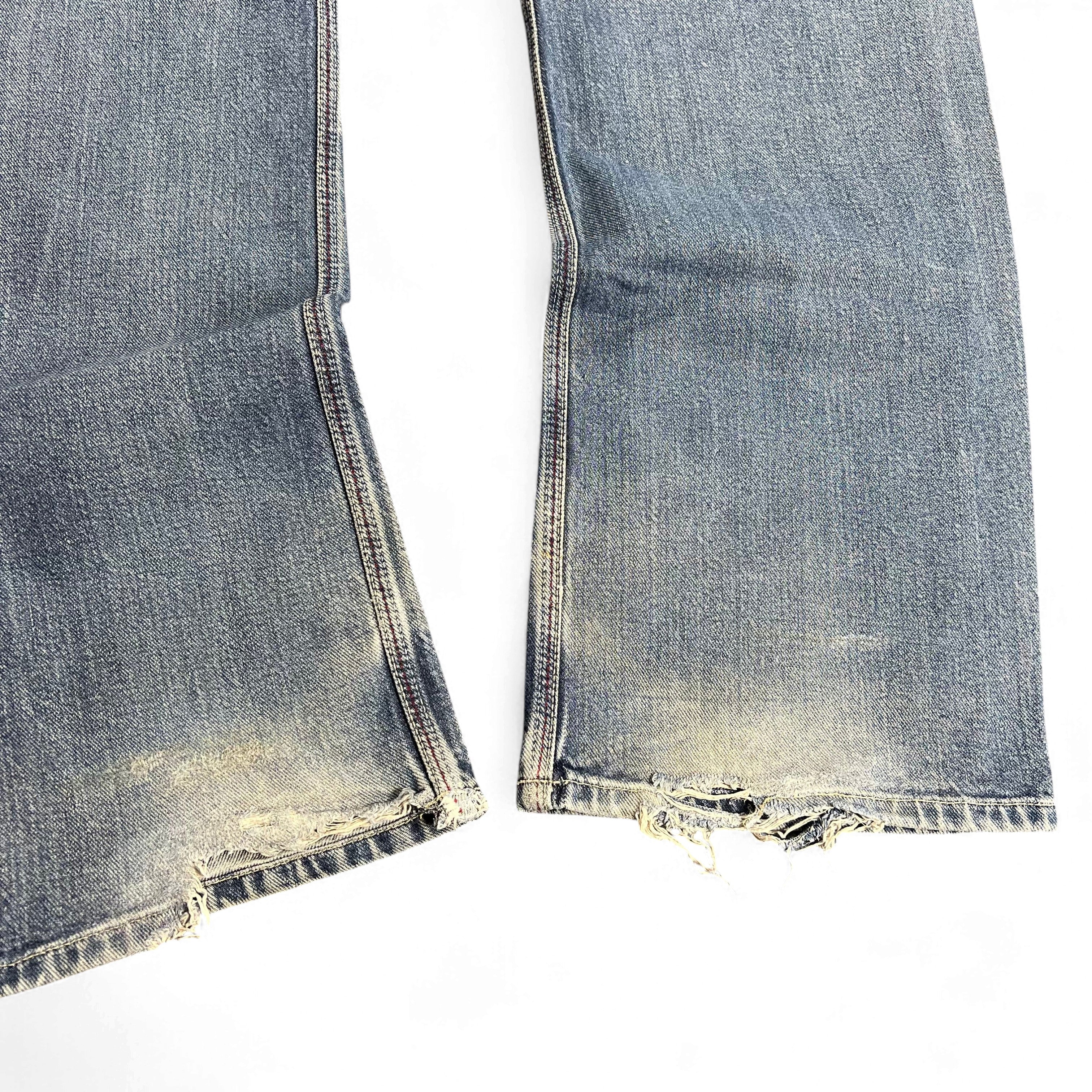 TWC Vintage Diesel Bootcut Jeans in verwaschenem Blau mit ausgefransten Säumen und Vintage-Details