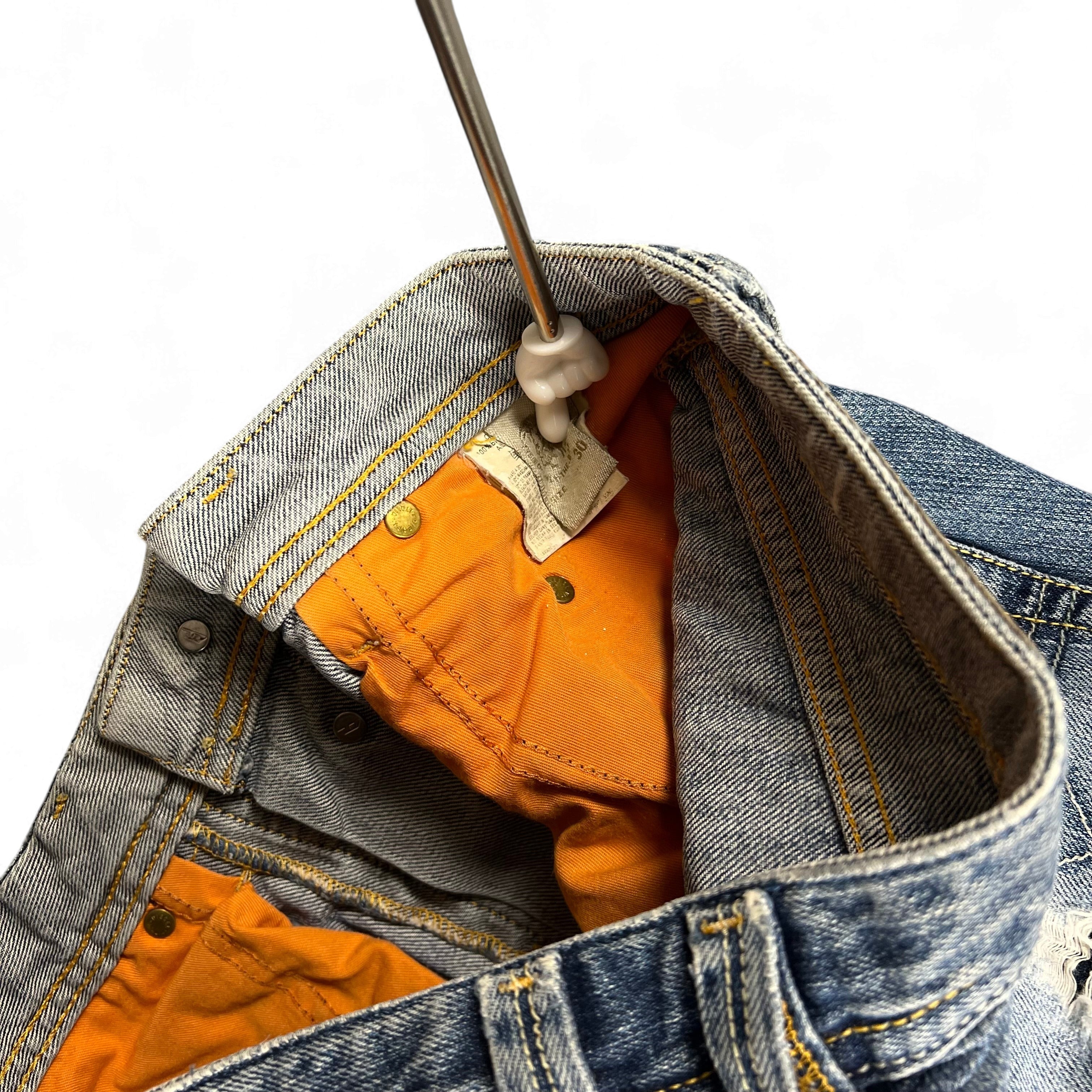 TWC Vintage Diesel Bootcut Jeans mit hellblauer Waschung und markanten orangefarbenen Innentaschen