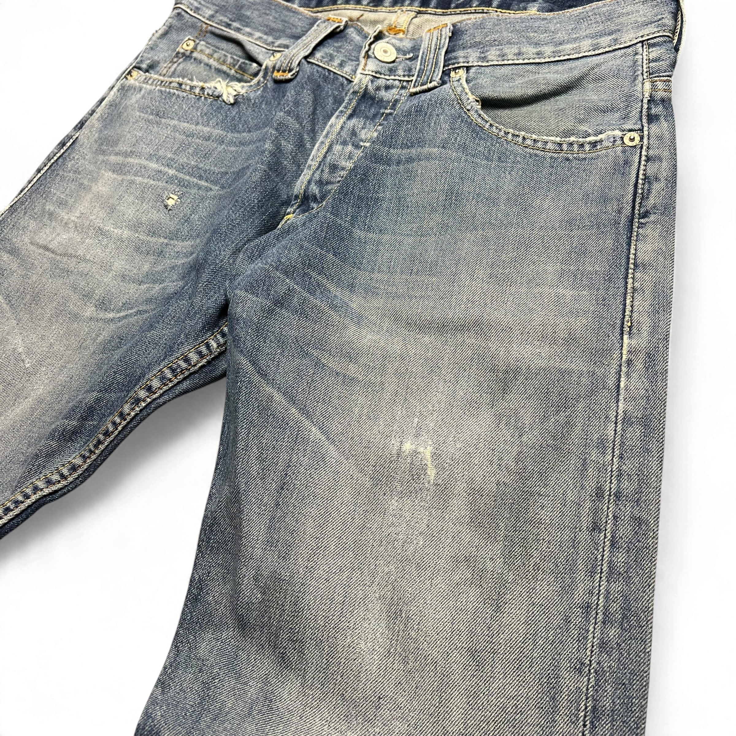 TWC Vintage Levi’s 512 Bootcut Jeans in dirty wash denim with distressed details and button fly closure.