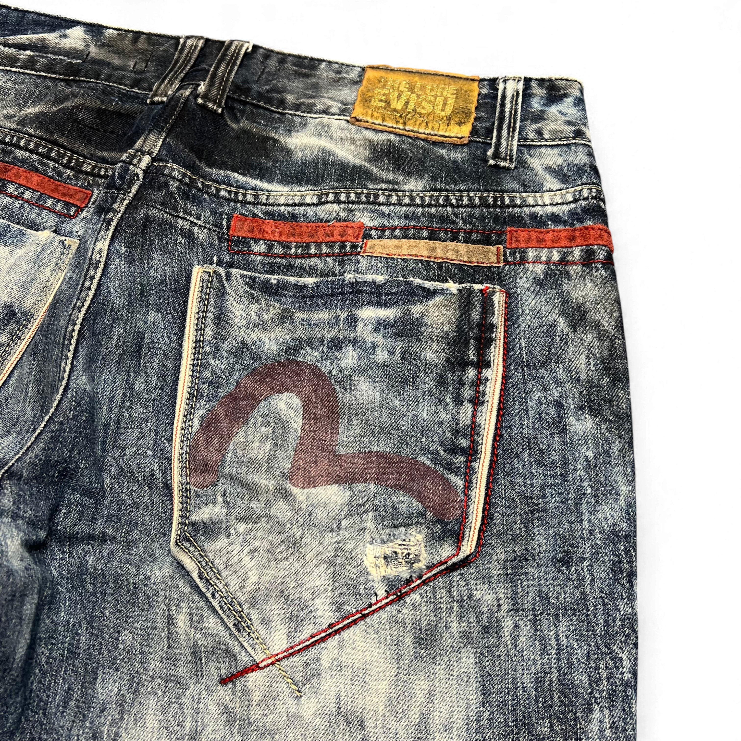 TWC Vintage Evisu KC Straight Jeans mit Acid-Wash-Optik, rotem Zierstreifen und ikonischem Logo auf der Gesäßtasche