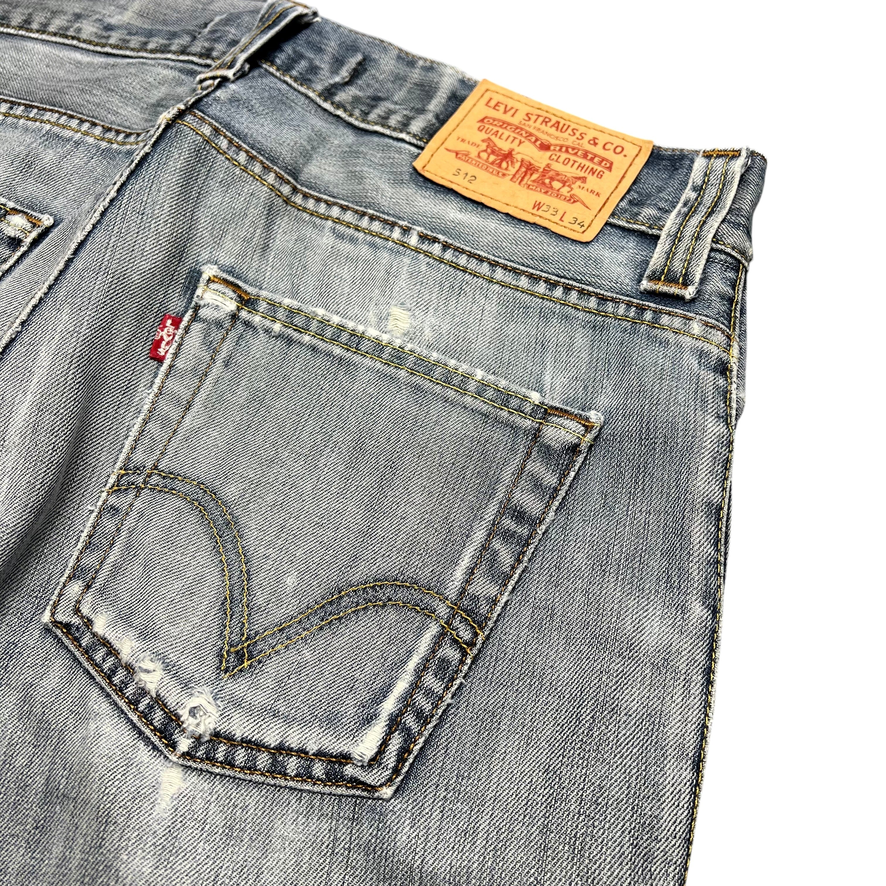 TWC Vintage Levi's 512 Jeans in verwaschenem Blau mit Distressed-Details und klassischem Leder-Patch