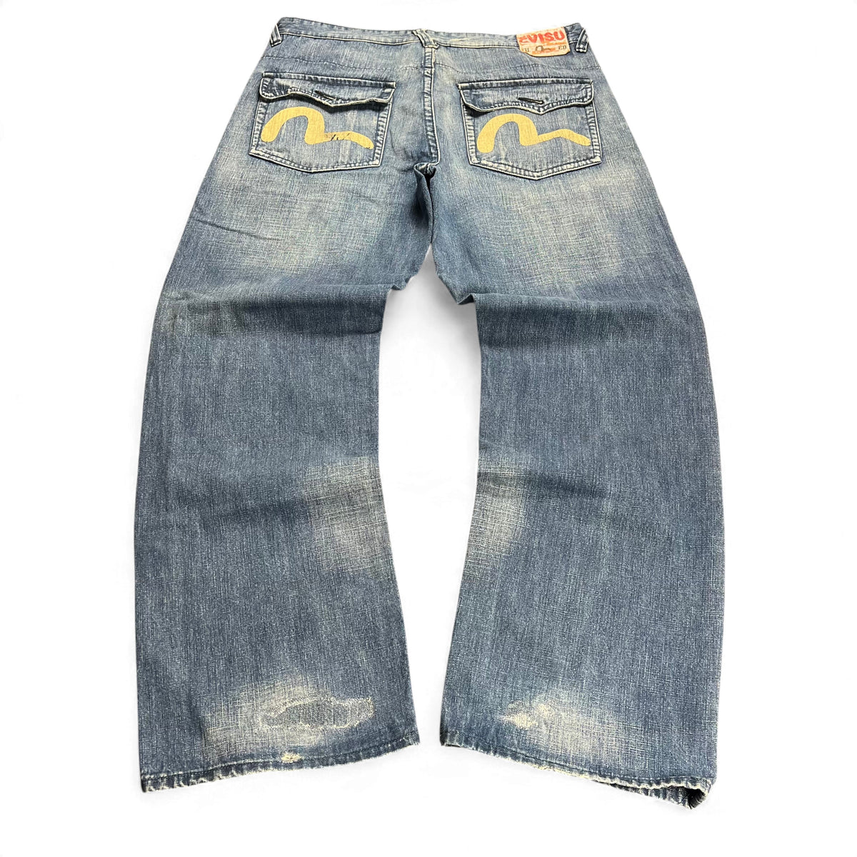 TWC Vintage Evisu Baggy Jeans in verwaschenem Blau mit ikonischen gelben Seagull-Taschenstickereien und Used-Look